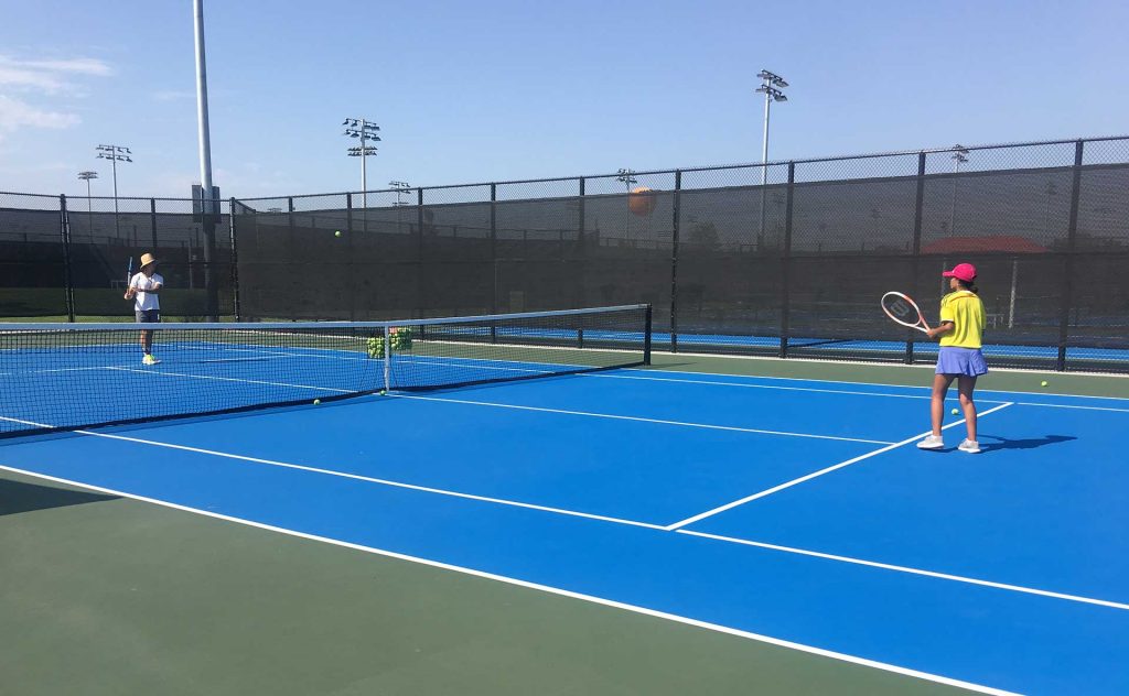 Adam coaching tennis