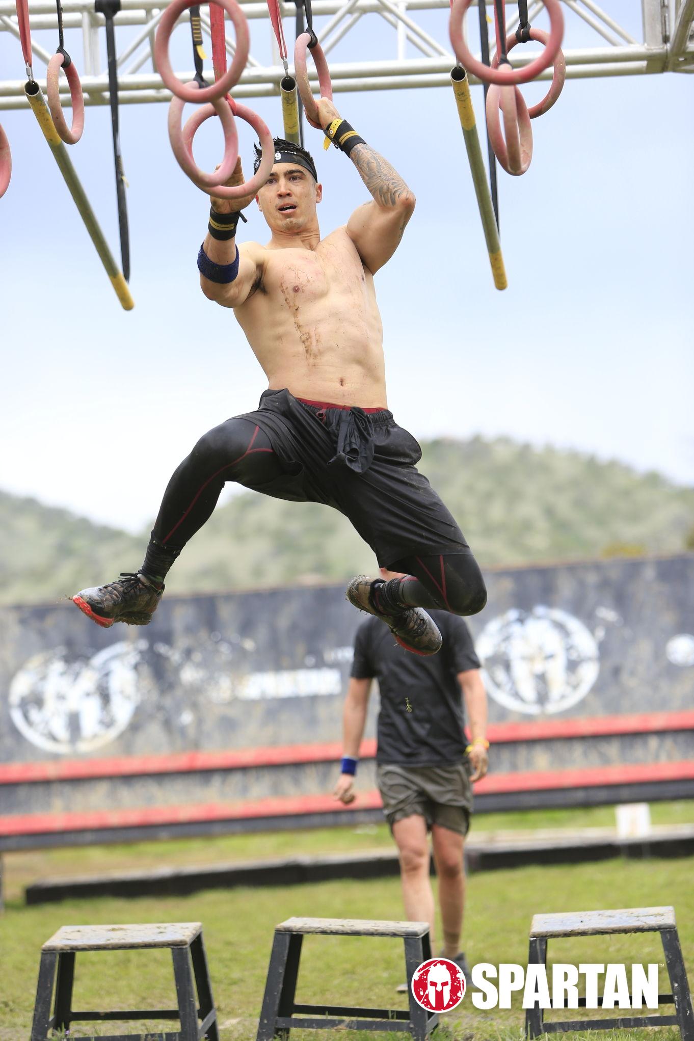 Adam crossing the multi-rings obstacle in the Spartan race