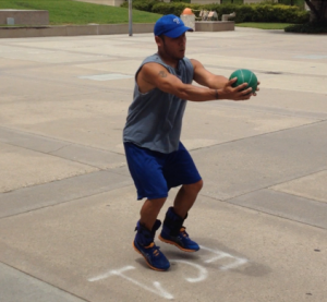 Teddy C. being trained with ankle weights and weight ball